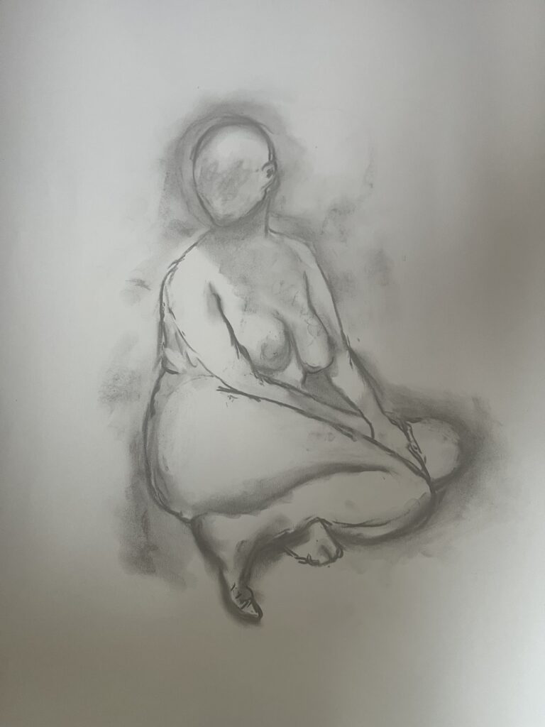 A charcoal drawing of a nude model who is seated on the floor. Her body is swivelled ninety degrees away from the viewer, her head is swivelled in relation to her body so that she is almost looking at the viewer.